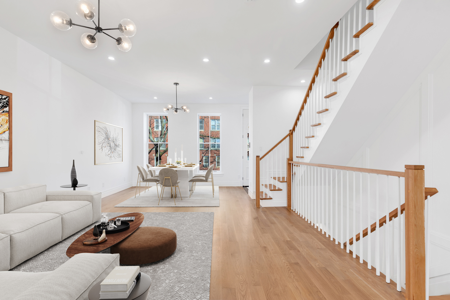 Remodel of townhouse living room with wood floors and white paint