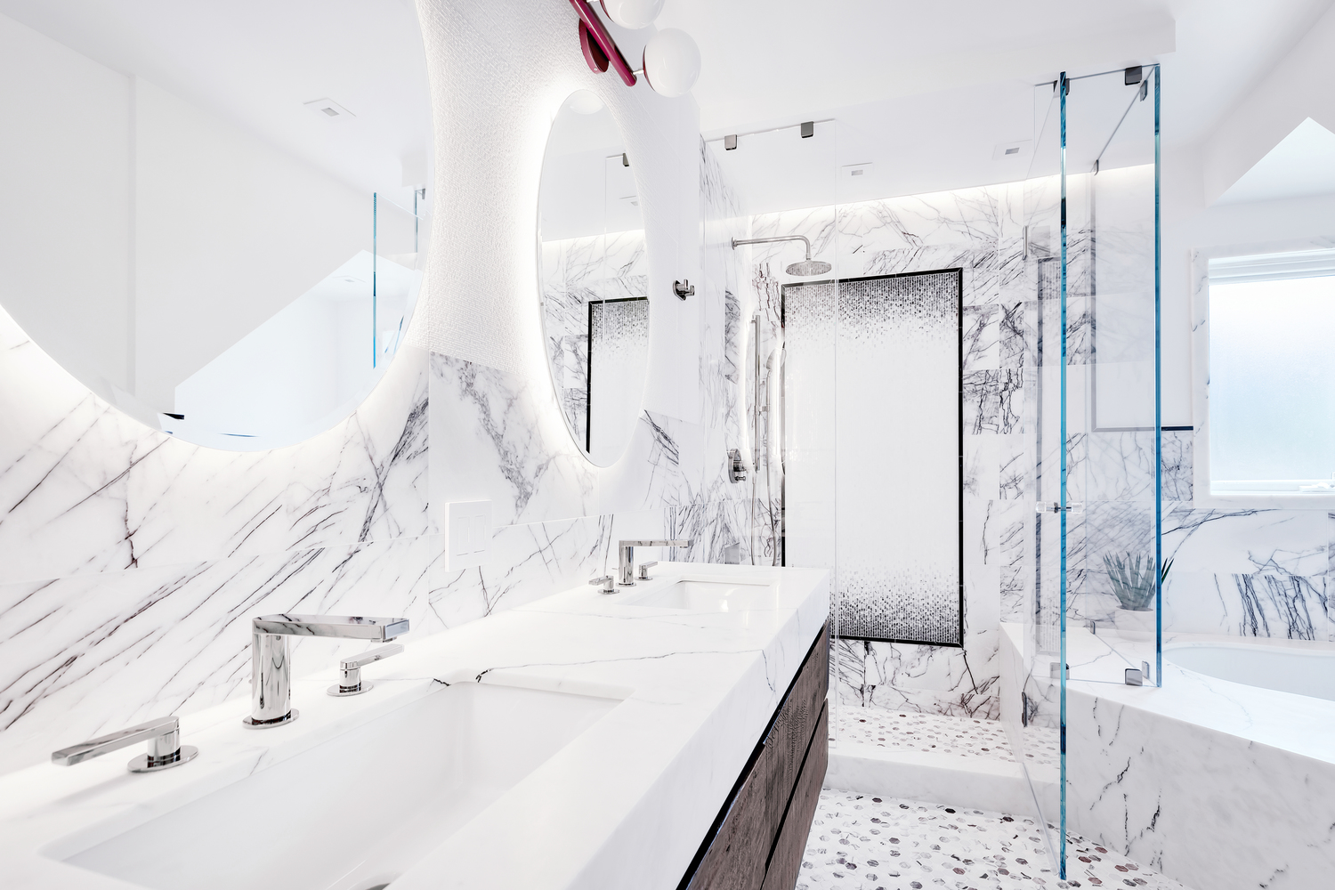 Remodeled bathroom with white tile walls and glass-enclosed shower.