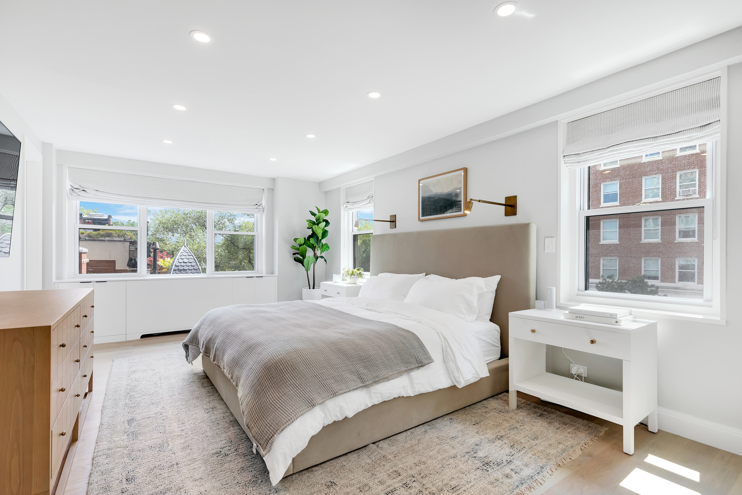 Remodeled bedroom with large windows and recessed lighting.