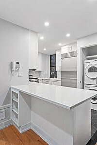 Modern kitchen with laundry appliances.